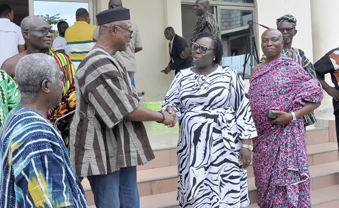 Togbe Kasa III, Dufia of Ho-Ahoe, and Justice Angelina Mensah-Homiah, a Justice of the Court of Appeal, in a handshake during the engagement at the Asogli palace, while other chiefs look on