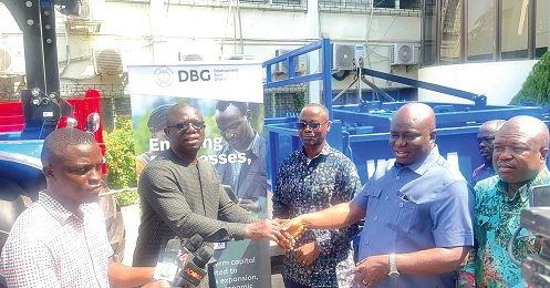 Eric Opoku (2nd from right), Minister of Food and Agriculture, in a handshake with John Kwame Mensah Zigah (left), Deputy CEO of Development Bank Ghana, while other dignitaries look on