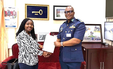 Air Commodore David Anetey Akrong (right), Commandant of KAIPTC, and Princess Sekyere-Bih, Director of KCC, displaying the document after the signing protocols