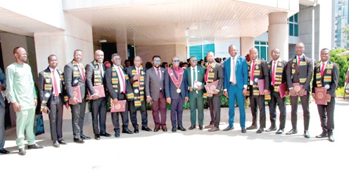 Henry Kwadwo Boateng (middle), President of IET-GH, with some of the inductees