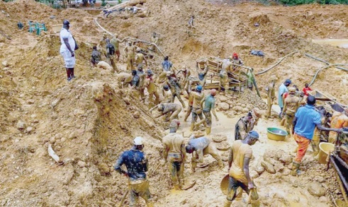 Some illegal miners busily mining Some illegal miners busily mining