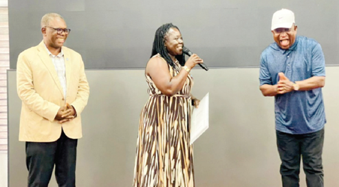 Samuel Magnus Asiedu (right), outgoing acting Executive Director, applauding, after presenting the handing-over notes to Dr Enyonam Kpekpena (middle), the new Executive Director, while  Ludwig Annang Hesse (left), President of GhIE, looks on