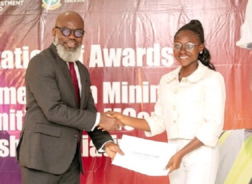 Issah Taylor, MP,  Tarkwa Nsuaem, presenting an award letter to one of the scholarship beneficiaries