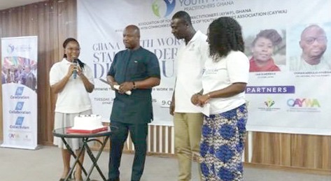 Inusah Mahama, Deputy CEO, National Youth Authority, and other officials cutting a cake to signify the relaunch of the Association of Youth Work Practitioners 