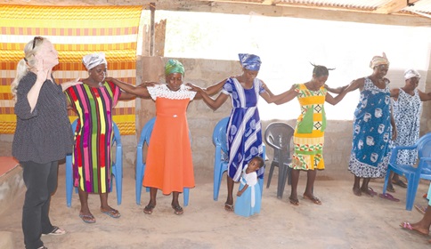 Mama Beth leading some widows in prayer and worship