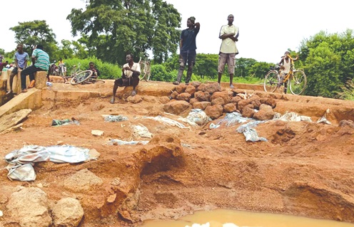 Residents fixing portions of the deplorable road with stones
