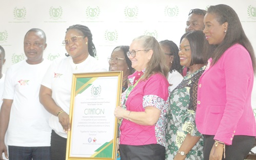 Gifty Abena Turkson (2nd from left), Deputy General Secretary of the Teachers and Educational Workers Union (TEWU), presenting a citation to Angela Vanderpuije (3rd from right), Vice Principal of the Lower Secondary School at Ghana International School, to commemorate World Teachers' Day 2025. Picture: ESTHER ADJORKOR ADJEI 