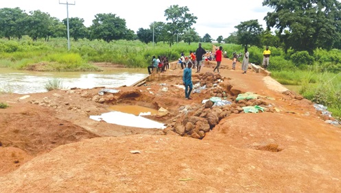 Some residents patching portions of the road to ease the situation