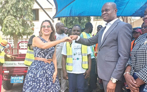 Salomé Azevedo (left), Managing Director of Nestlé Ghana, handing over keys to the tricycles to Yusif Sulemana, Deputy Minister of Lands and Natural Resources