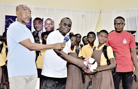 Rev. Isaac Owusu (2nd from left), National President of GNAT, presenting a football to one of the beneficiary learners Rev. Isaac Owusu (2nd from left), National President of GNAT, presenting a football to one of the beneficiary learners