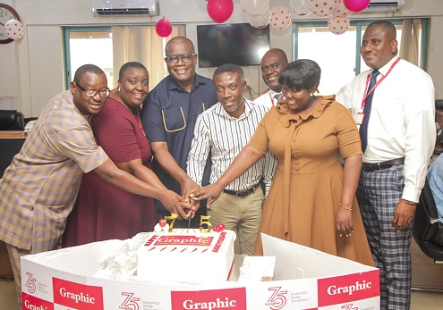 Theophilus Yartey (3rd from left), Editor, Graphic, with Phoebe Odoom (2nd from right), Sales and Marketing Coordinator of Labadi Beach Hotel, Charles Amoako (middle), Director Technical; Samuel Essel (3rd from right), Director, Finance and Administration; and Franklin Sowa (right), Director, Marketing & Sales, Samuel Ablordeppey (left), News Editor; and Mary Mensah (2nd from left), Foreign Editor; cutting the cake. Picture: CALEB VANDERPUYE
