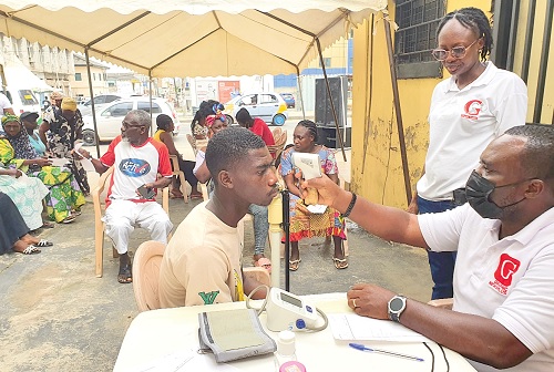 A nurse checking the vital statistics of a participant A nurse checking the vital statistics of a participant