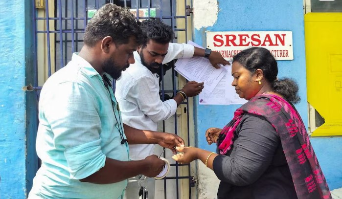 [1/2]A state health official sticks a notice outside the Sresan Pharmaceutical factory whose Coldrif cough syrup has been linked to the deaths of 17 children in Madhya Pradesh, in Chennai, India, October 7, 2025. REUTERS/Praveen Paramasivam Purchase Licensing Rights