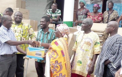 Dr Stephen Manortey (left), Head of Programmes of Ensign Global University, presenting an item to Manye Maku I (3rd from right),  Manya Krobo Divisional Queenmother for Kpong