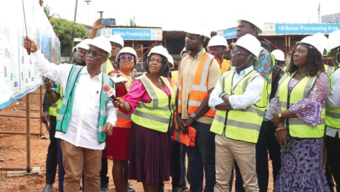 Richard Dade (left), Project Manager, La General Hospital, showing some architectural designs to Kwabena Mintah Akandoh (2nd from right), Minister of Health, during his visit to the site. With him are Rita Odoley Sowah (right), Member of Parliament for La Dade Kotopon and Alfredos Nii Anyetei (standing behind minister), MCE, La Dade Kotopon.  Picture: BENEDICT OBUOBI