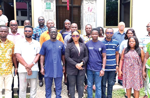   Benjamin Teye Larweh (2nd right), Deputy Public Affairs Manager of COCOBOD, and Eric Gyamfi (3rd from left), MCE, Agona West Assembly, with staff of the assembly after the courtesy call.