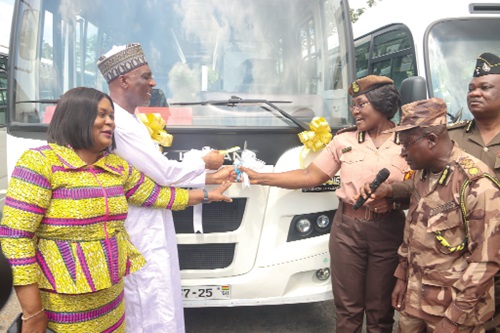 Muntaka Mohammed-Mubarak (2nd from left), Minister for the Interior, being assisted by Patience Baffoe-Bonnie (2nd from right), Director-General, Ghana Prisons Service, to cut the tape to commission the new buses. Picture: ELVIS NII NOI DOWUONA 