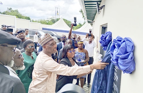 Alhaji Muntaka Mohammed-Mubarak, Minister for the Interior, unveiling the plaque to officially inaugurate the Eastern Regional National Signals Bureau Command Office in Koforidua