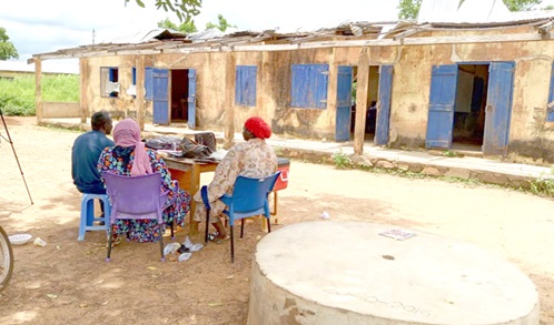 Teachers sit under a tree due to lack of office space