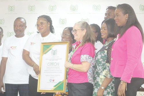 Gifty Abena Turkson (2nd from left), Deputy General Secretary of  TEWU, presenting a citation to Angela Vanderpuije (3rd from right), Vice Principal of the Lower Secondary School at Ghana International School, to commemorate World Teachers' Day in 2025. Picture: ESTHER ADJORKOR ADJEI 