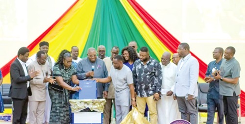 George Justice Arthur (arrowed), Cape Coast MCE, Nana Brew-Butler (with mic), Chairman, Implementation Committee, and others unveiling the document
