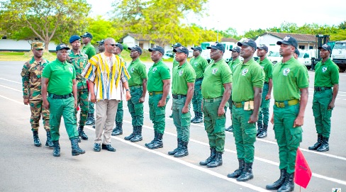 Courage K. M. Nunekpekau (in smock), MD of TDC, inspecting the guard of honour of the security task force during their passing out ceremony