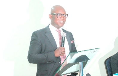 Daniel Klu (inset), acting Head, Cyber and Information Security, Bank of Ghana, delivering a speech on behalf of Dr Johnson Pandit Asiama, Governor, Bank of Ghana. Participants applauding at the WAIFEM Conference.  Pictures: ERNEST KODZI 