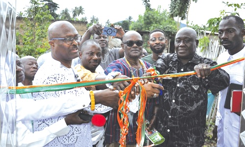 Bishop Francis Afotey Odai (left) being assisted by Francis Dusey (2nd from right), Ho West DCE; Togbe Ewe I (middle), Amedzrofia of Kpedze-Awlime B; Tomas Kudiabor (2nd from left) to commission the water system