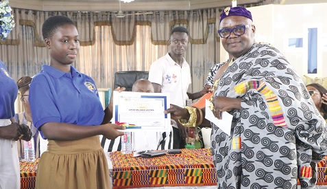 Mildred Adoma Ofori of Crystal Springs Community School receiving the Overall Best BECE candidate award from Nana Sasu IV, Awosohene of Akyem Kotoku Traditional Area Mildred Adoma Ofori of Crystal Springs Community School receiving the Overall Best BECE candidate award from Nana Sasu IV, Awosohene of Akyem Kotoku Traditional Area