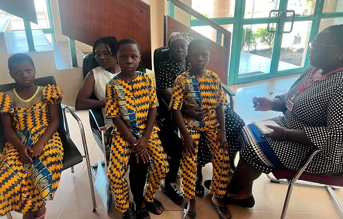 Louisa Kukua Barnes (right), our reporter,  with Peter, Paul and Pearl, the triplets; their grandmother (in scarf) and aunty