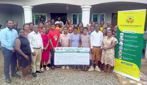 Alexander Opoku Ayitey (left), Santasi Area Manager, Asa Savings and Loans Limited, with the beneficiary students and their parents Alexander Opoku Ayitey (left), Santasi Area Manager, Asa Savings and Loans Limited, with the beneficiary students and their parents