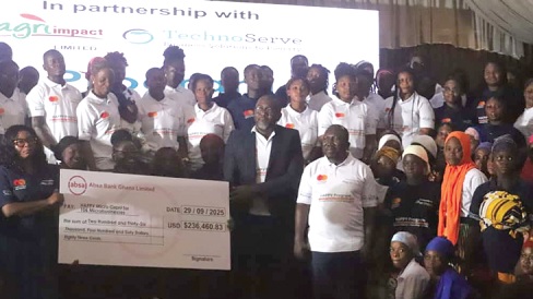 Frank Obiora (middle), Programme Director, TechnoServe, and some dignitaries with a section of the beneficiaries, after he presented a dummy cheque for the grant to the 106 beneficiaries. Those with them include Nana Kofi Riverson (4th from right), Monitoring, Evaluation and Learning Lead, Agri-Impact Limited. Picture: Emmanuel Baah