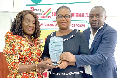Mary Brown (left), Vice-President of the Holy Child Old Students Association, presenting the humanity award to Mavis Kwainoo. With them is Yahaya Alhassan, Founder, Humanity Magazine