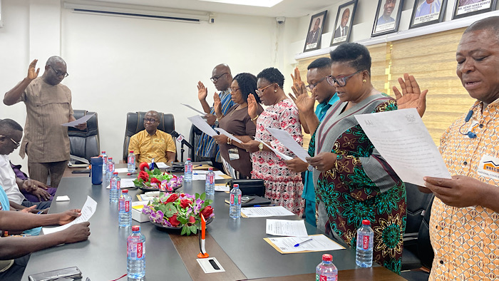 Mr Thomas Thompson-Aryee (left), Acting Director-General of the Internal Audit Agency, swearing in members of the newly inaugurated audit committee of the National Food Buffer Stock Company (NAFCO) 