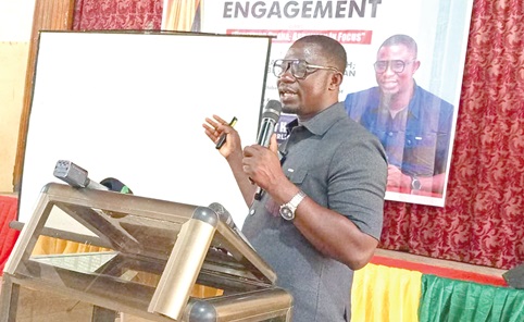 Dr Enerst Norgbey (right), MP, Ashaiman Constituency, speaking to constituents at the community engagement.