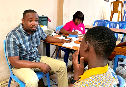 Dr Godwin Asamoah  Ahiakwao Principal Optometrist, Ga North Municipal Hospital, attending to a student at the screening Dr Godwin Asamoah  Ahiakwao Principal Optometrist, Ga North Municipal Hospital, attending to a student at the screening
