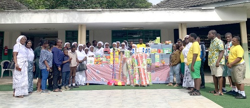 Members of the group with students and management of the school and the items donated