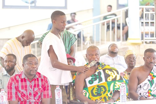 Nana Kwaku Budu Akomeah V (arrowed), Aduanahene and Benkumhene of the Akwamu Traditional Area, speaking at the gathering. Seated left is Godwin Bobobee, DCE of Asuogyaman