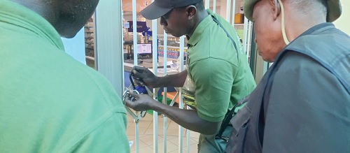 Members of the TDC Ghana Ltd Taskforce locking up the premises of a business indebted to the organisation Members of the TDC Ghana Ltd Taskforce locking up the premises of a business indebted to the organisation