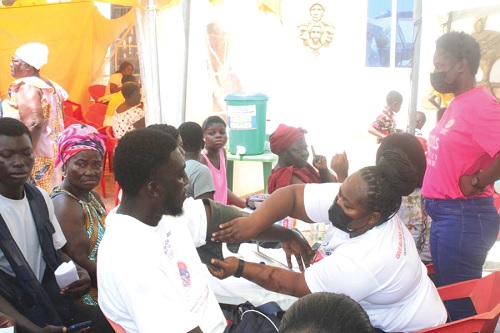 A health officer (right) attending to a patron at the health screening