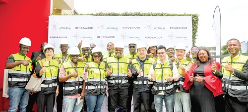 The delegation in vests with the management of Appolonia City