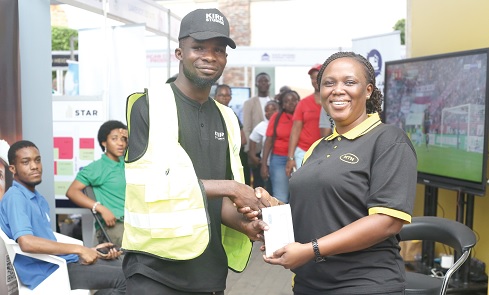 Gloria Adutwumwaa-Frimpong (right), Senior Manager, Data Devices and Home, MTN, presenting a Samsung Galaxy phone to Emmanuel Annang, the winner of the raffle game at the Daily Graphic-GREDA Home Fair held in Accra. Pictures: BENEDICT OBUOBI Gloria Adutwumwaa-Frimpong (right), Senior Manager, Data Devices and Home, MTN, presenting a Samsung Galaxy phone to Emmanuel Annang, the winner of the raffle game at the Daily Graphic-GREDA Home Fair held in Accra. Pictures: BENEDICT OBUOBI