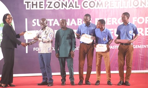 Eunice A. Britwum (left), acting Executive Secretary, Energy Commission, presenting a prize to Obed Ackom, the Project Coordinator, Legon Presbyterian Boys SHS, for emerging winners of the Southern Zone of the Energy Commission SHS Renewable Energy Challenge organised in Kumasi