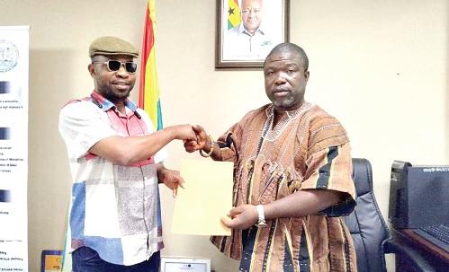 Richard Kasu (left), Executive Director, CFF-Ghana, presenting the communique to James Gunu, Volta Regional Minister