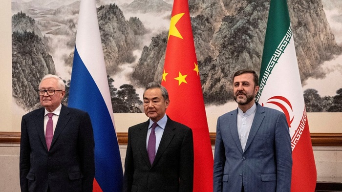 CHINESE FOREIGN MINISTER Wang Yi is flanked by Russian Deputy Foreign Minister Sergey Ryabkov (left) and Iranian Deputy Foreign Minister Kazem Gharibabadi at a meeting on the Iranian nuclear issue in Beijing in March.