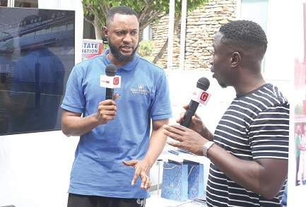 Kweku Zurek (right), Assistant Editor, Graphic Online, speaking to a representative from Eden Heights