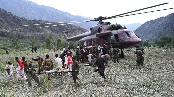 Rescuers work around rough terrain on board helicopters