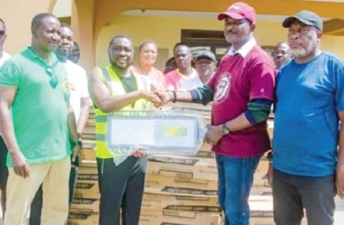 George Justice Arthur (2nd from left), MCE for Cape Coast, receiving 100 streetlights from Kweku Ricketts Hagan, Member of Parliament for Cape Coast South, to boost street lighting and security