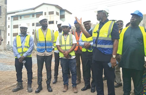 Courage Nunekpeku (2nd from right) explaining the extent to which work has been carried out during the tour of the Kpone Affordable Housing Project site at Community 26.