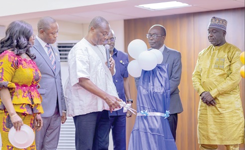Prof. George K.T. Oduro (with mic), Technical Advisor to the Minister of Education, cutting the tape to launch the academic journal